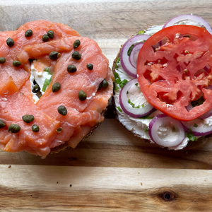 Open-faced Nova lox sandwich with lox, red onion, tomato, scallion cream cheese and capers
